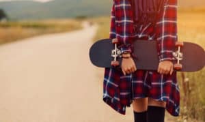 how to hold a skateboard while walking